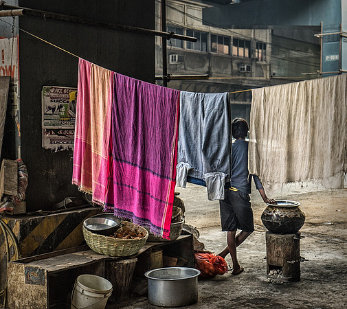Man Standing Among Laundry