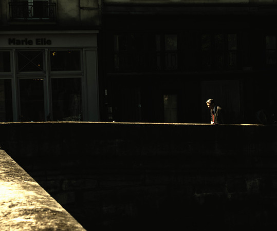 Sunlit Man on Bridge